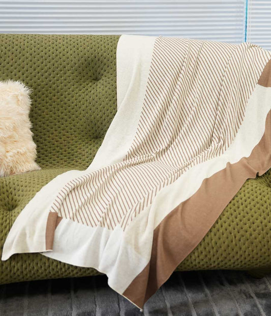 Wool blend throw blanket in camel and beige with stripe patterns putting on sofa