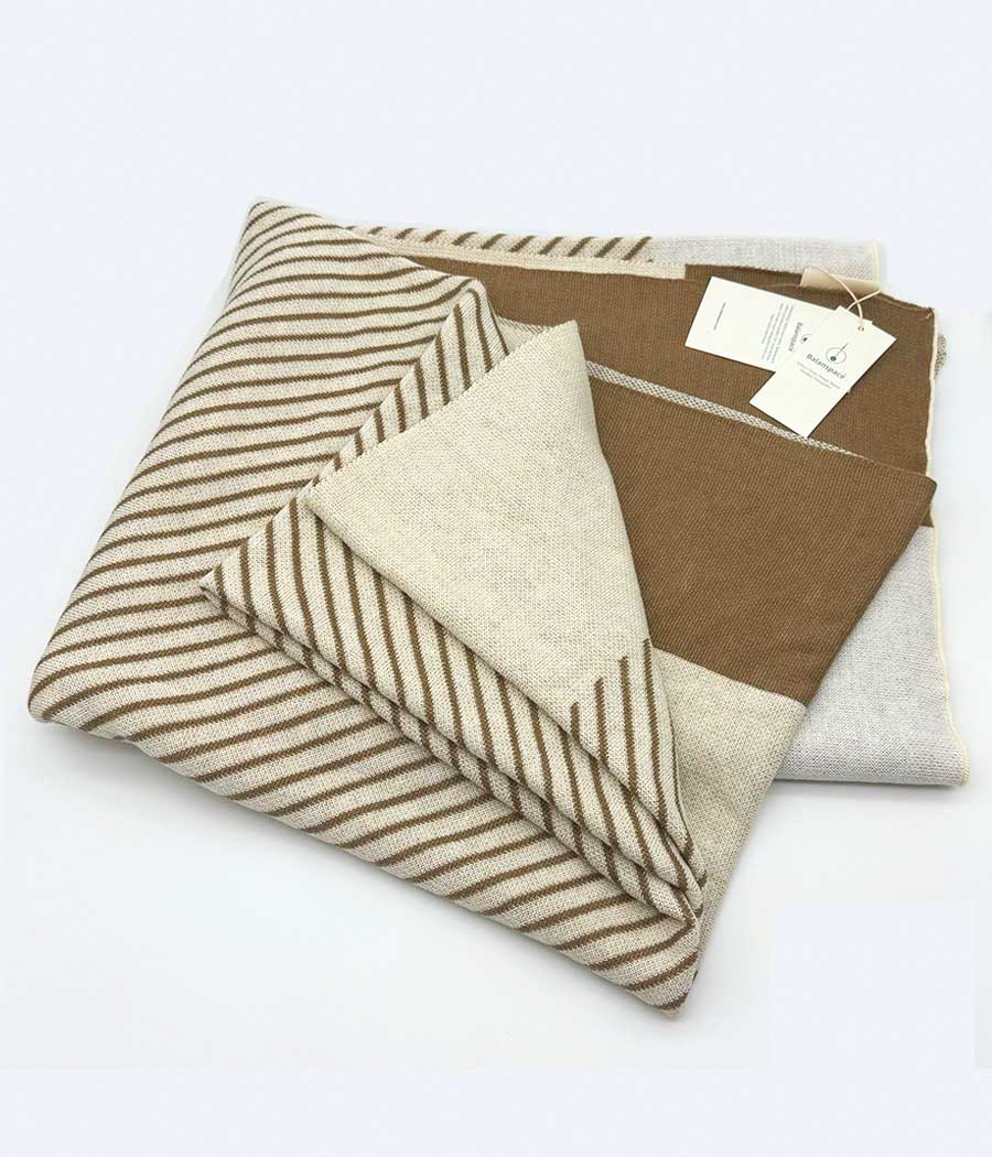 Wool blend throw blanket in camel and beige with stripe patterns | folded