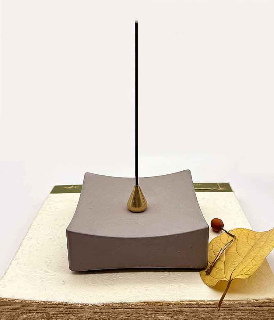 Concrete incense burner put on a book