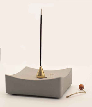 Concrete incense burner in white background