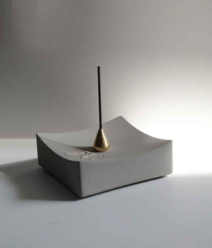 Concrete incense burner on a table