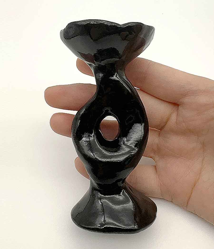 Handcrafted Nordic style ceramic incense burner in black held by a hand