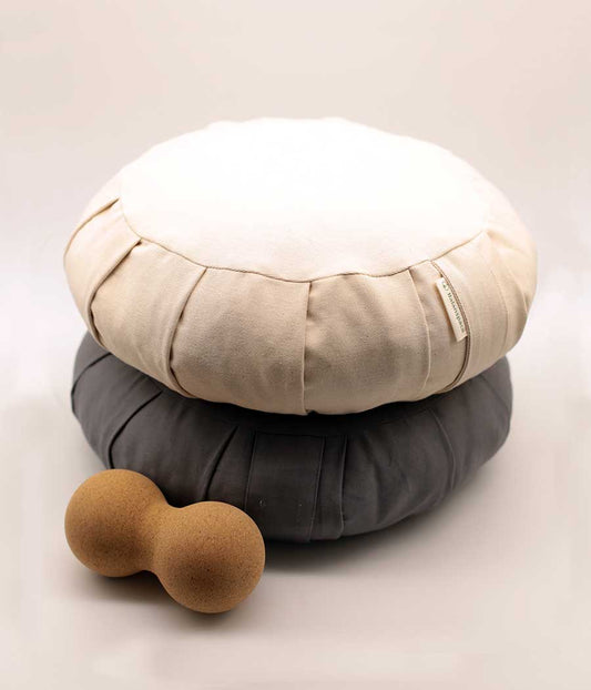 Cotton Zafu meditation cushion in plain white on top of a grey cushion