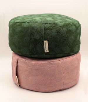 Vintage jacquard Zafu meditation cushion in green velvet on top of pink cushion