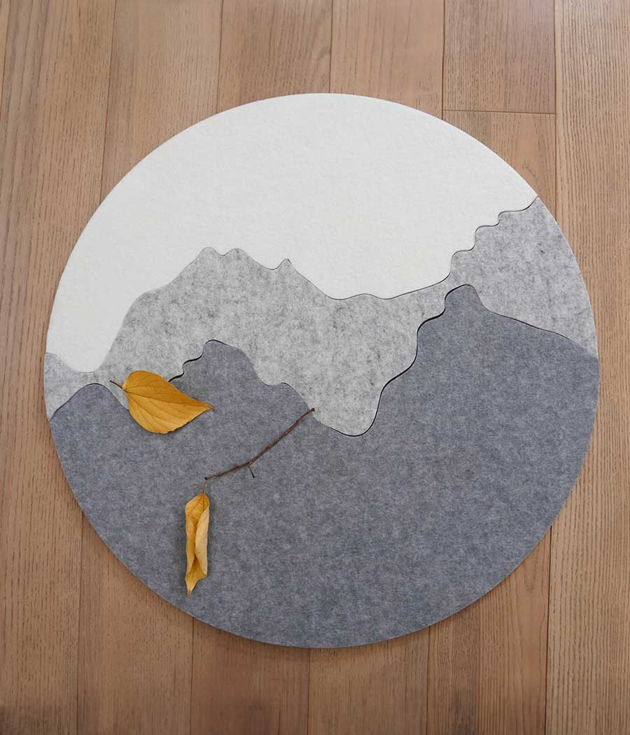 Round felt wall bulletin board with landscape pattern on wood background